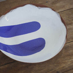 Small terracotta serving bowl with a grey base coat and two brush strokes of blue glaze