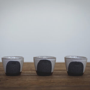 Small grey glazed espresso cup with a splash of black glaze on the front // Cwpanau espresso gwydrog bach llwyd gyda sblash o wydredd du ar y blaen