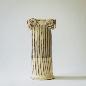 off-white Grecian column vase with vertical ridges. Shown on a white backdrop 