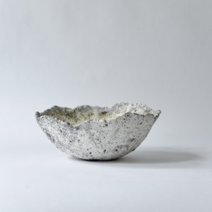 white and grey, heavily textured dining bowl, set against a white backdrop.