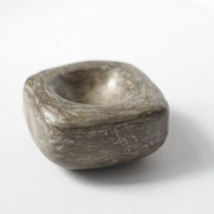 a square, hand moulded and unfired clay dish 