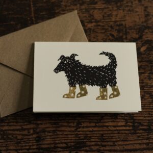 Lino cut print of a collie sheep dog wearing a pair of star patterned boots
